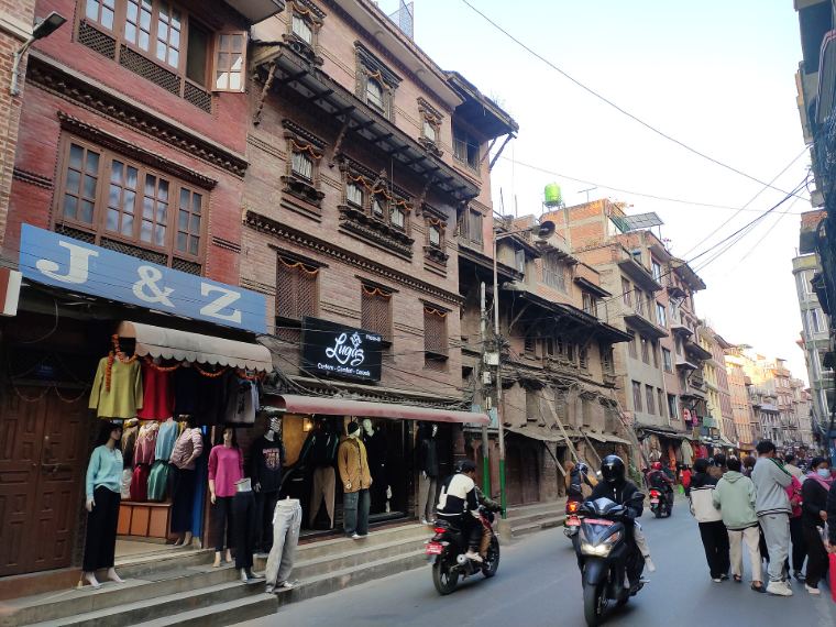 A busy lane of old brick buildings near Patan Durbar Square